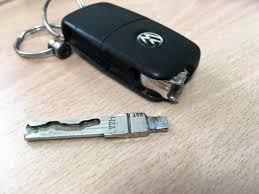 "Broken car key held in hand, illustrating the need for key replacement and repair services offered by Ants Locksmithing."